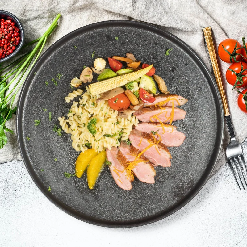 B. Duck Breast L'Orange W/ Mix Vegetables And Quinoa Pasta